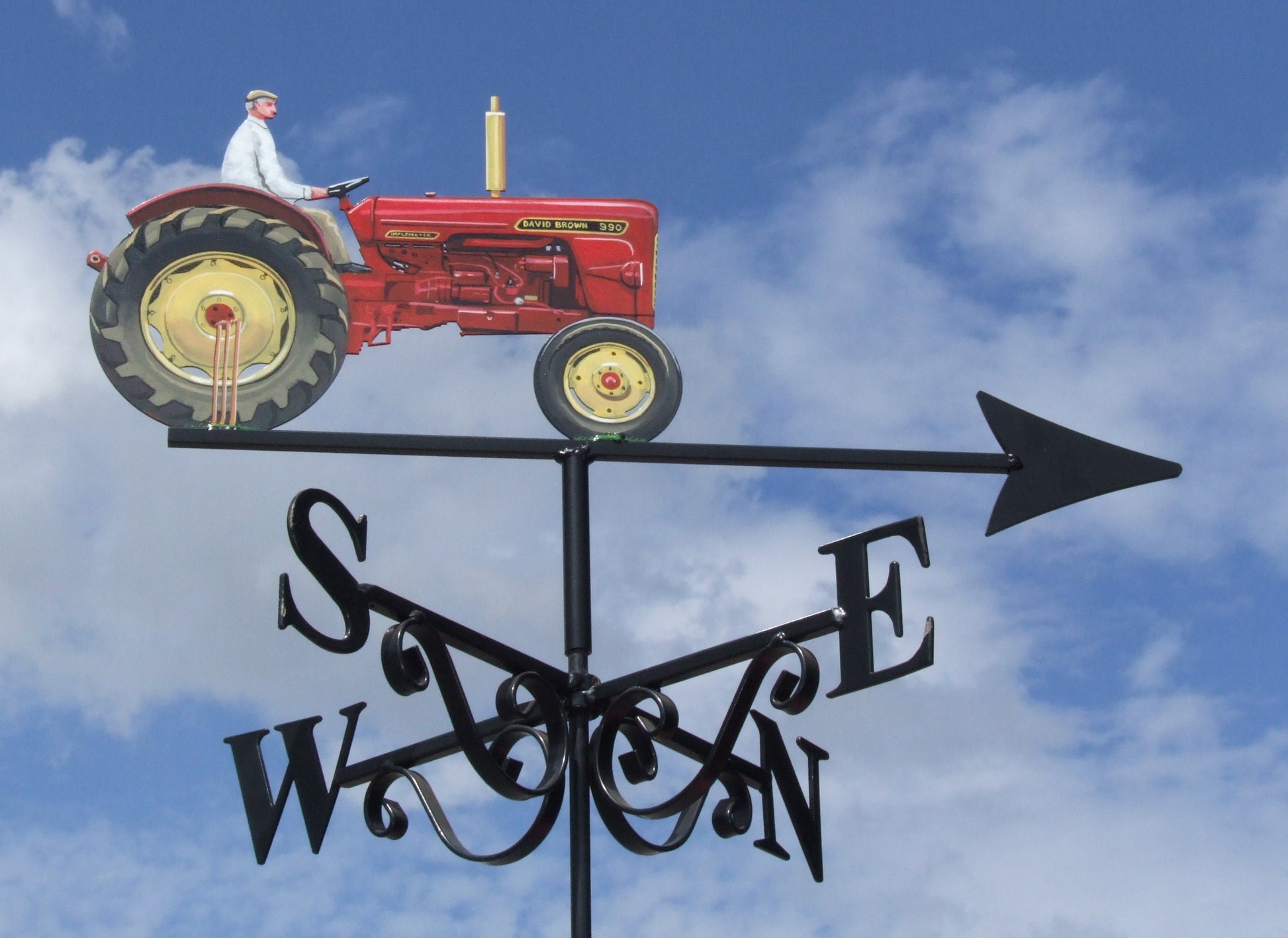 A red David brown tractor with a man and cricket stumps artist painted weather vane right side